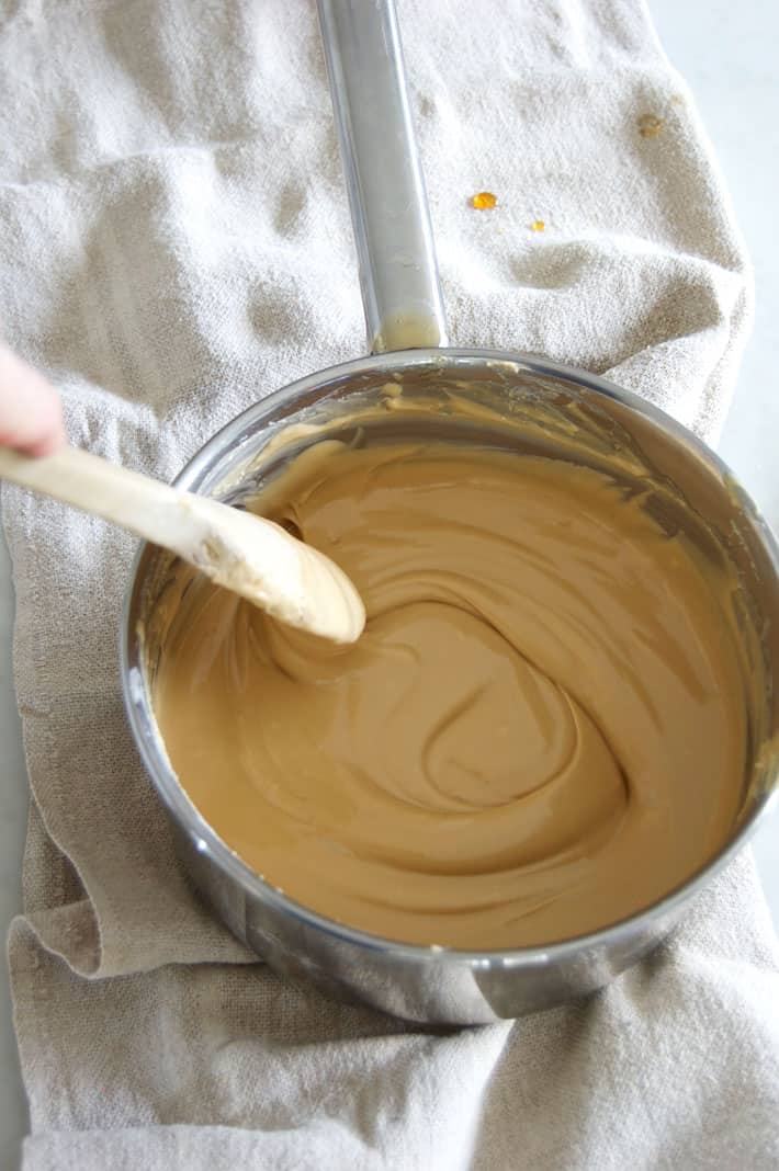 The last stages of stirring maple cream. The wood spoon leaves trails behind it.