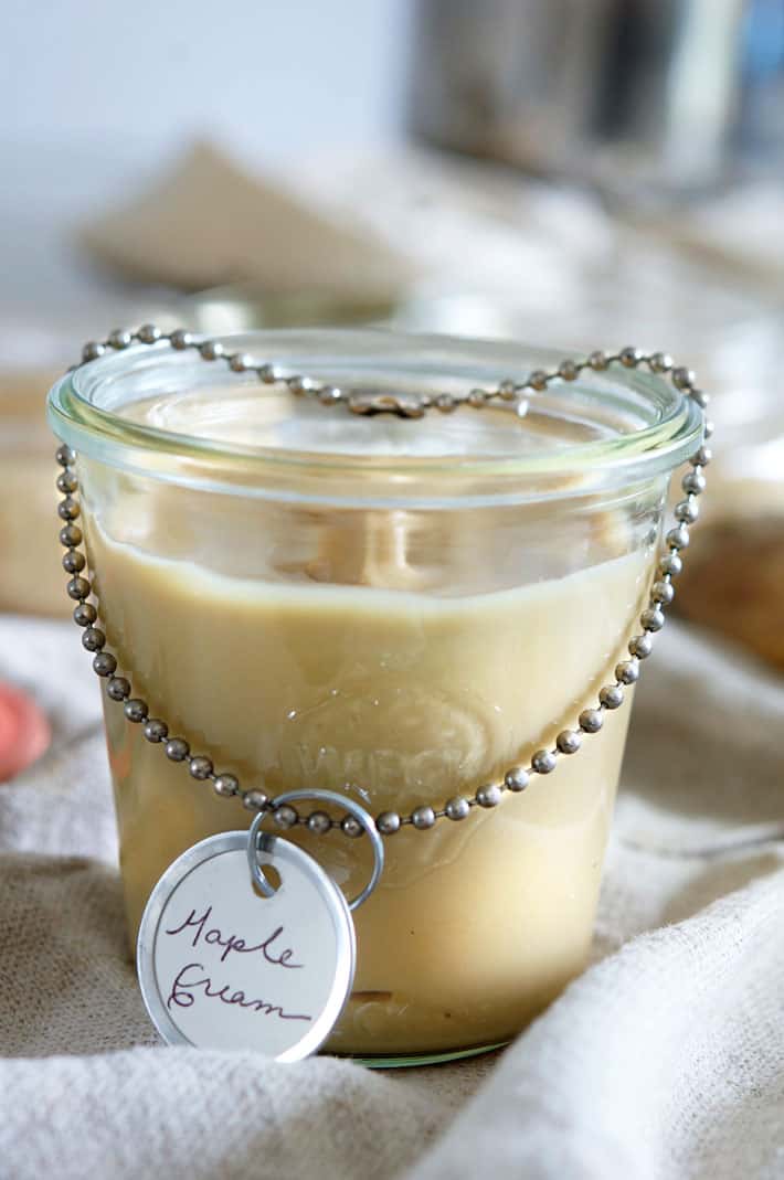 Weck jar filled with maple cream draped with silver chain with tag reading "Maple Cream".