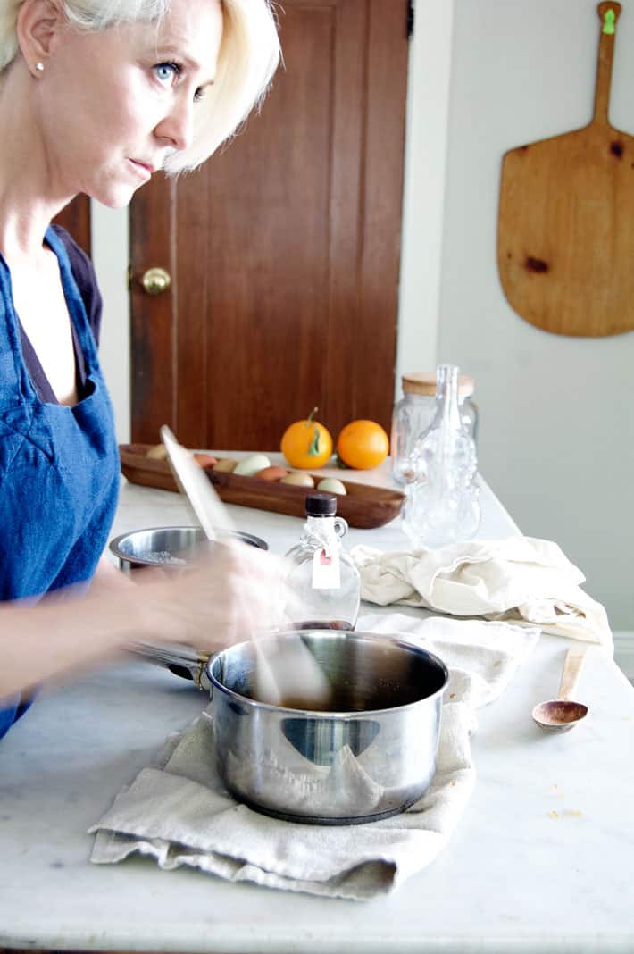 Karen Bertelsen stirring maple syrup in pot.