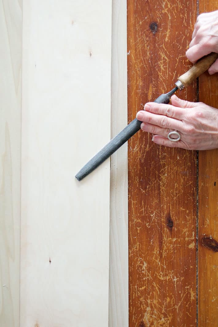 Filing off screw tips with metal file.