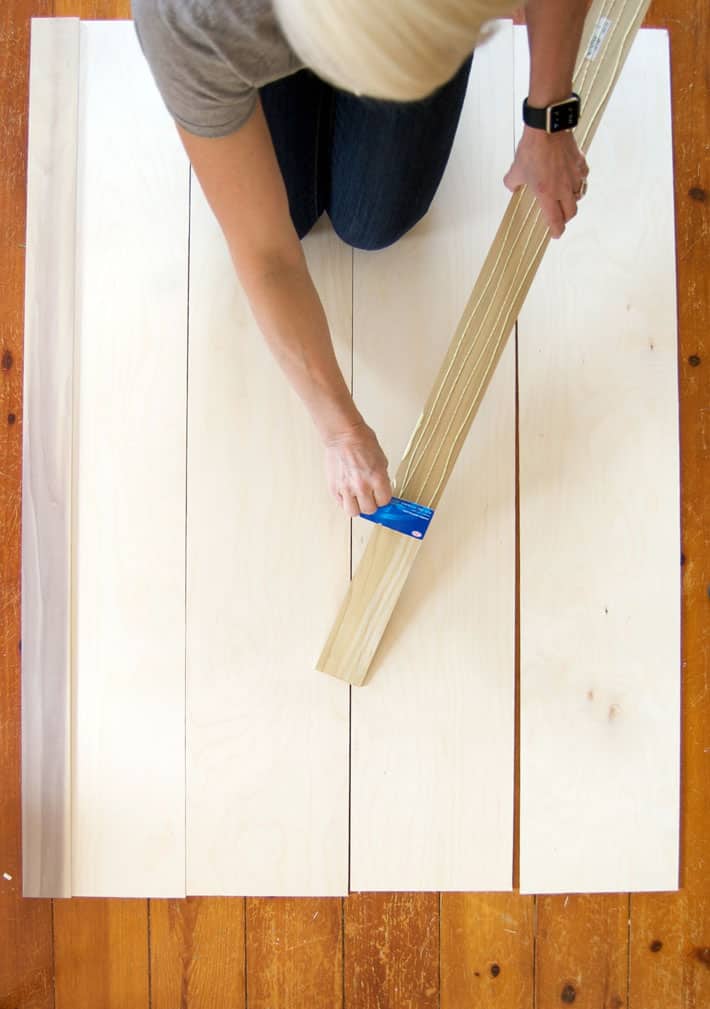 How to build interior shutters! Spreading glue on wood trim with old credit card.