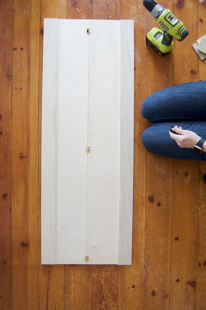 Partially made birch plywood interior shutters laying on pine floor.