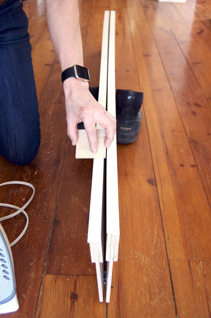 Rolling edge banding with block of wood.