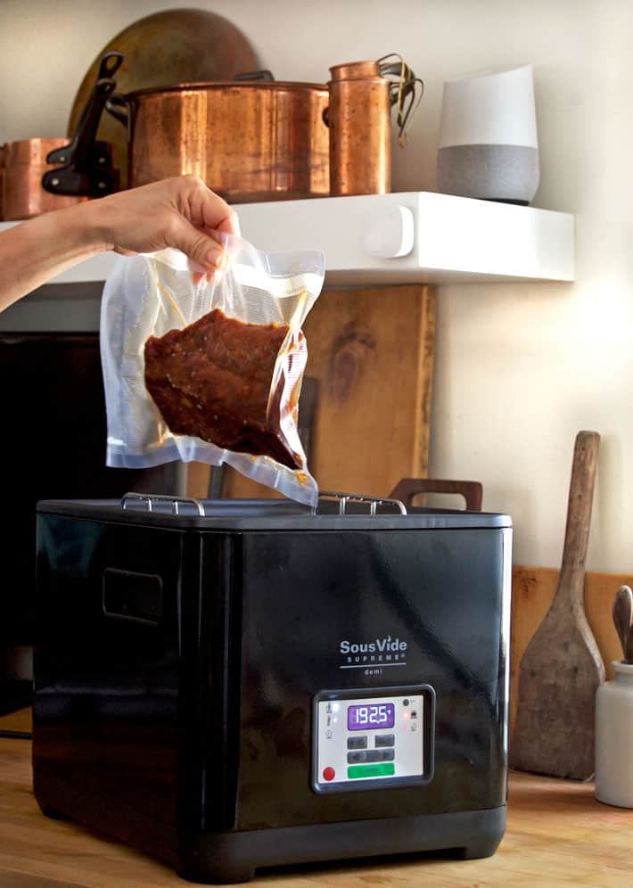 Setting bagged ribs into Sous Vide machine.