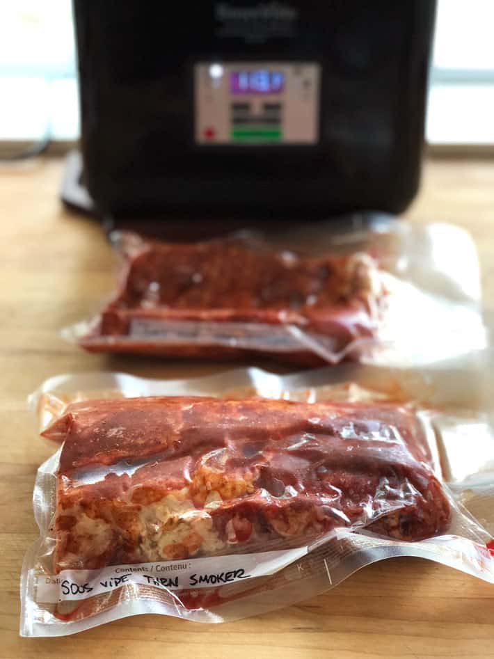 Vacusealed ribs on butcher block counter.