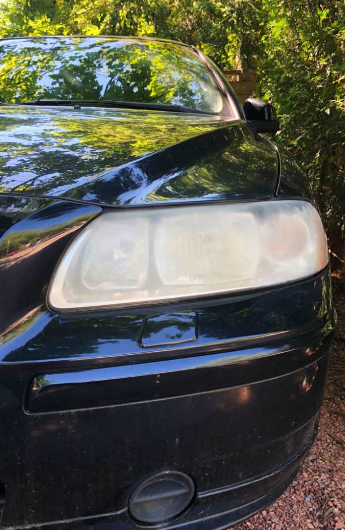Cloudy car headlight so opaque that light can barely get through.