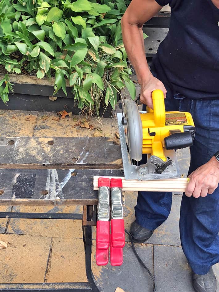 Cutting a handful of dowels with a circular saw.