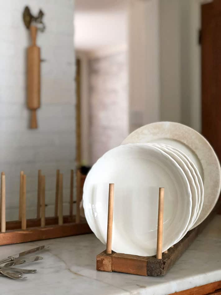 DIY plate rack filled with vintage ironstone plates and bowls.