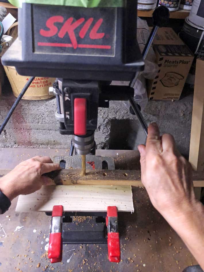 Lowering the handle on a drill press.