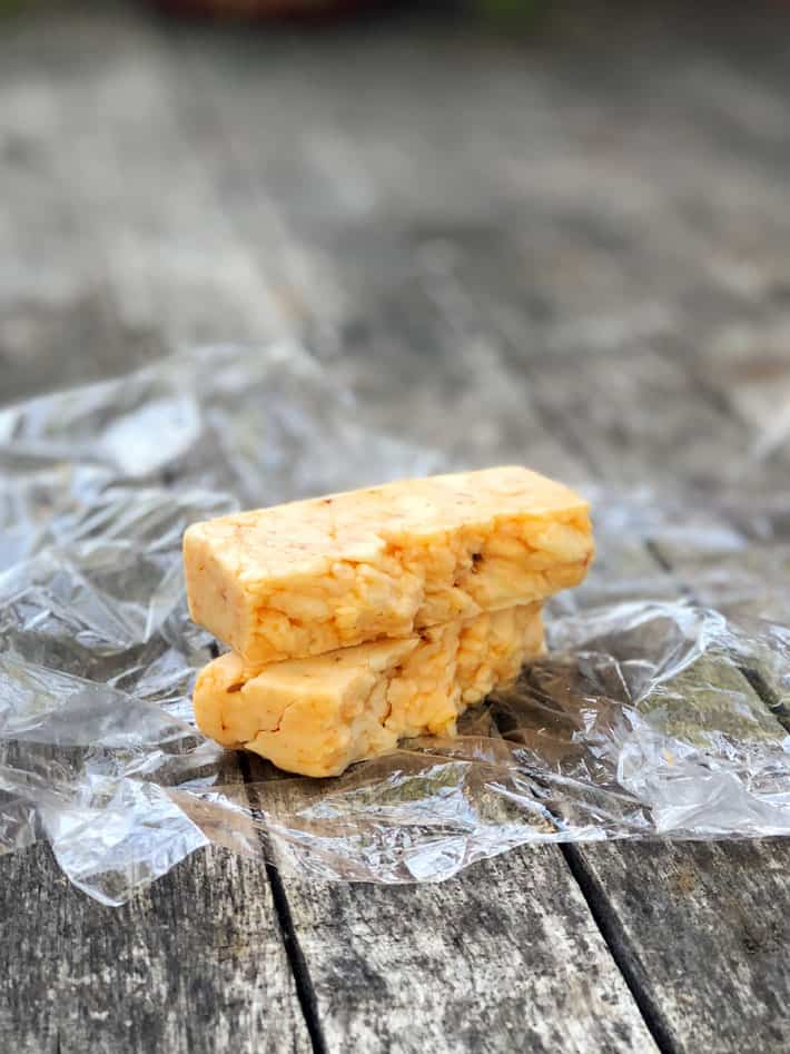 7 of the tastiest cheese options for your burger. A thick square of cheddar Jalapeno cheese broken in half.