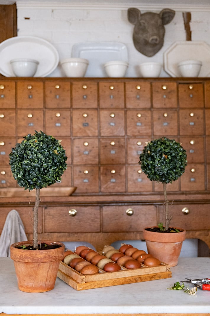 Artificial DIY topiaries in farmhouse kitchen.