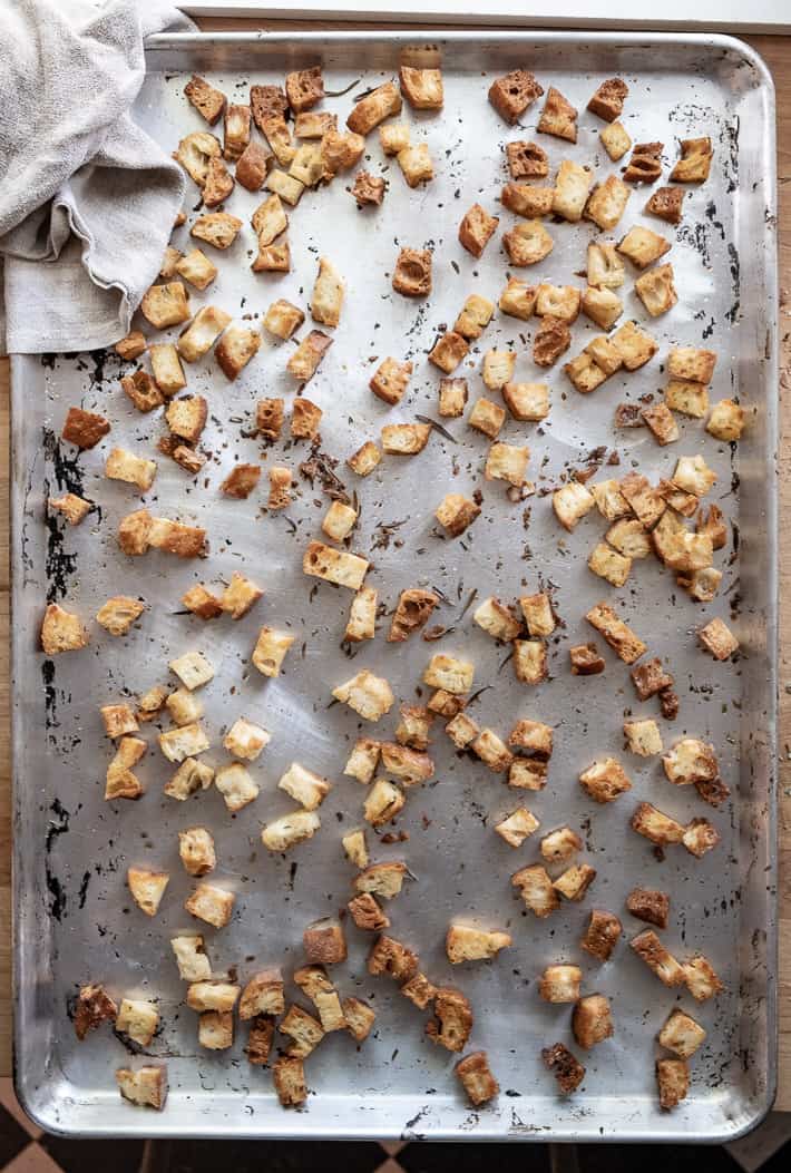 Well browned croutons on a worn baking sheet fresh from the oven.
