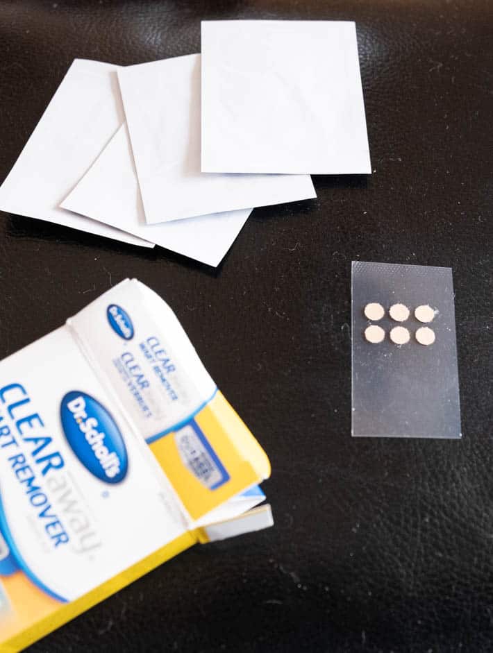 Dr. Scholl's wart remover kit laid out with the bandaids, box and small patches of Salicylic Acid.