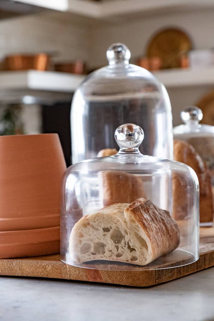 Want fresh bread? Try one of these methods. Glass domes with some ventilation at the bottom storing bread.