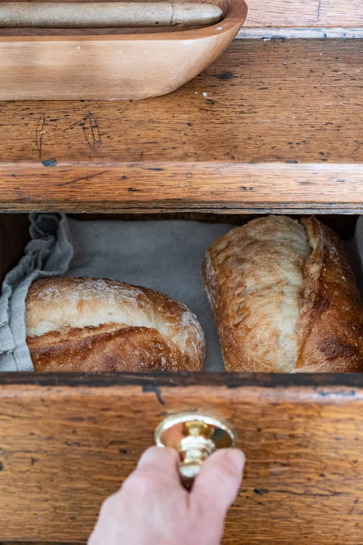 Bread stored on a linen cloth in a bread drawer.