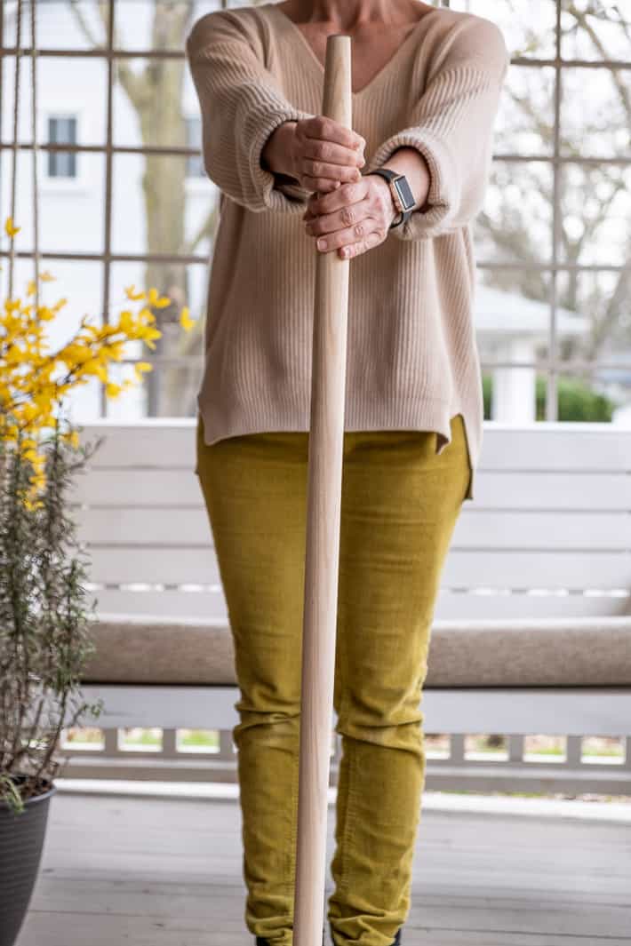 Karen Bertelsen (wearing chartreuse pants) holding a brand new shovel handle.