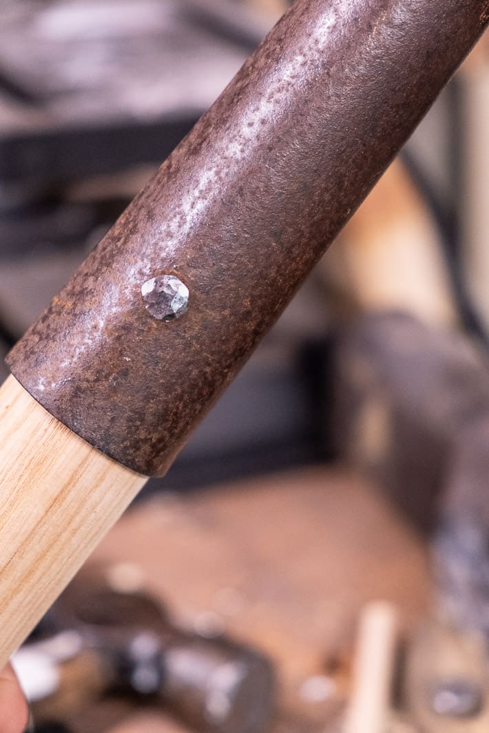 Gleaming hand hammered rivet that's been flatted out while replacing an old shovel handle with a new one.