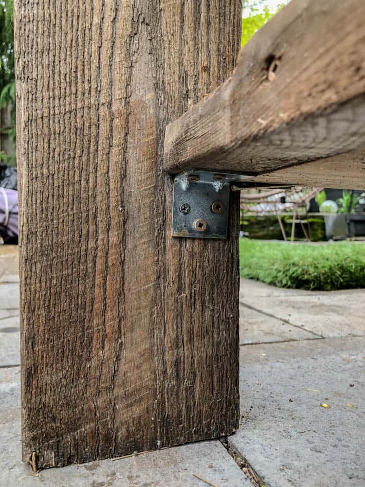 The seats of a Restoration Hardware outdoor sectional are L-bracketed to the corner from underneath. 