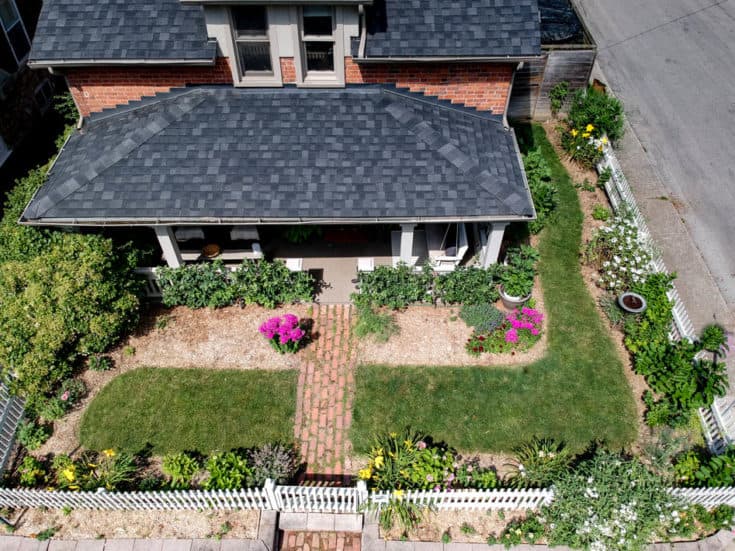 Overhead view of English Cottage Garden and front of historic red brick cottage house. 