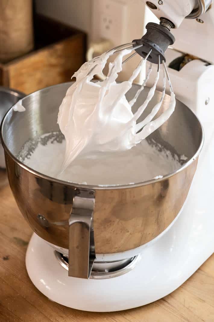 Beater and mixing bowl with beaten egg whites. 