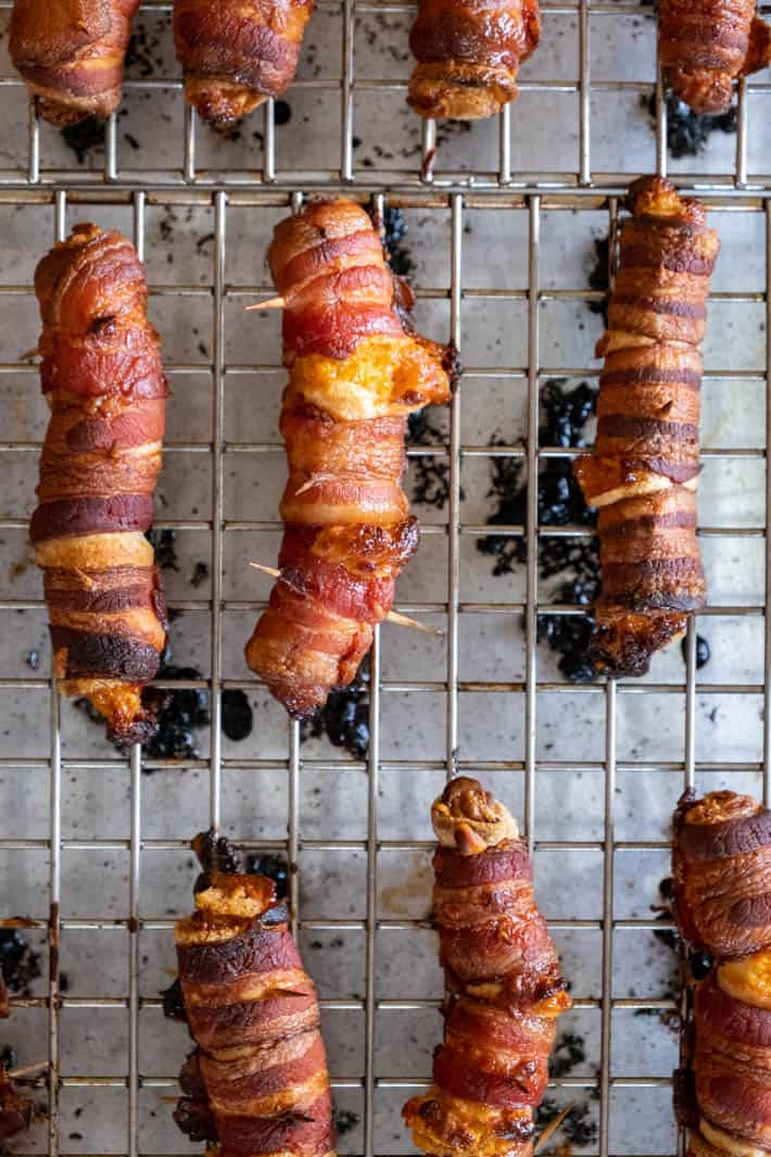 Crispy, salty bacon wrapped around gooey cheese filled bread. THE holiday appetizer. Cooked bacon wraps, oozing with cheese just out of the oven.