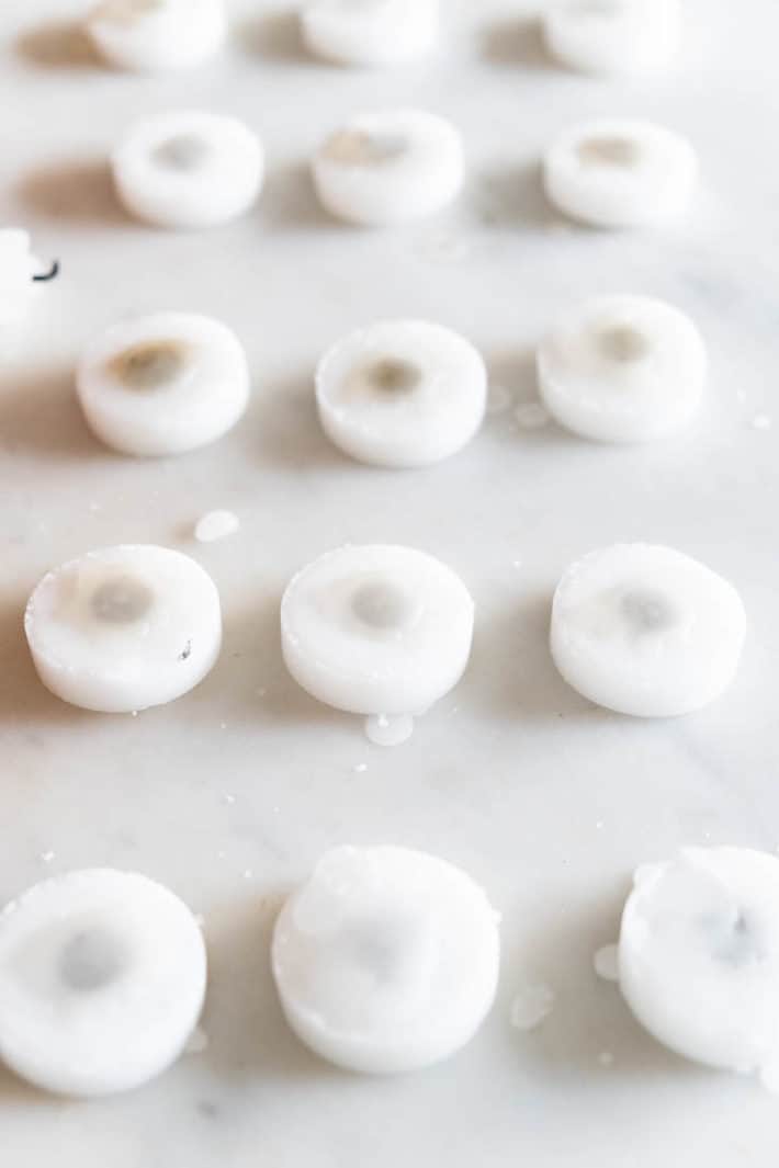 The underside of rows of tea lights, sealed with wax.