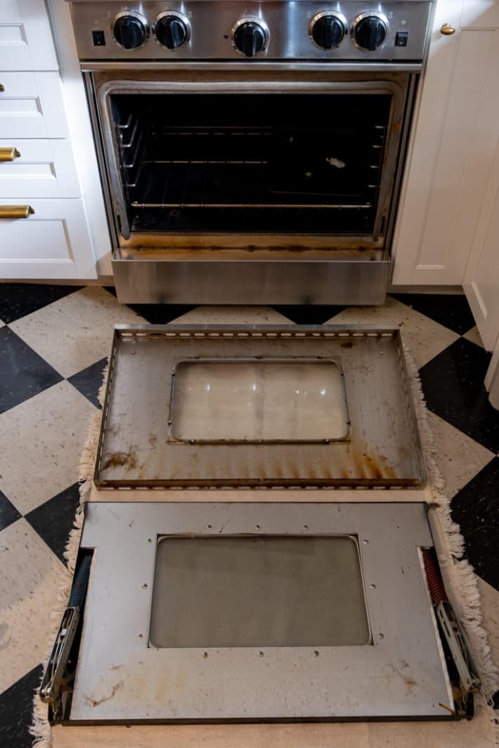 A Blue Star range oven door disassembled to clean in between the oven window glass.