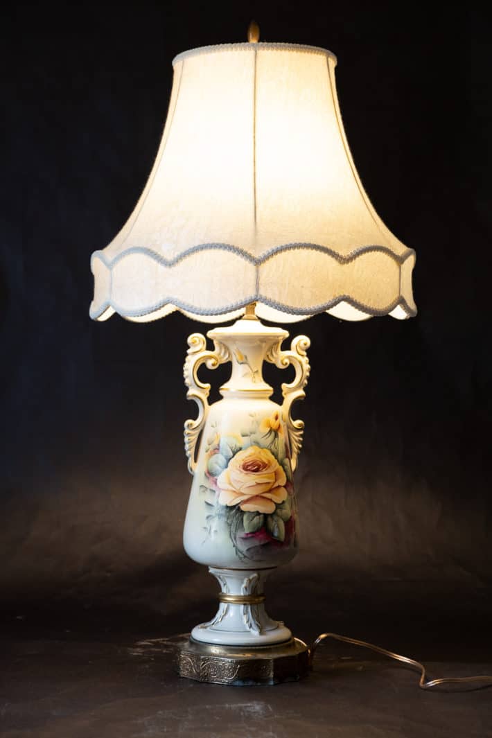 Vintage ornate painted lamp with original shade and new wiring.