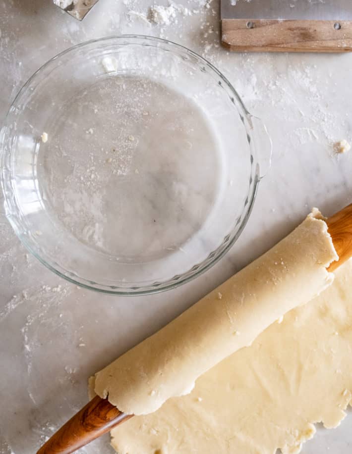 Rolled out pie dough wrapped around a french rolling pin.