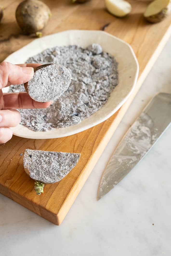 A seed potato with the cut wound dusted in wood ash to help prevent rot.