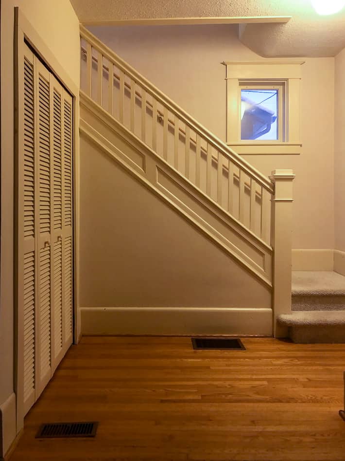 All beige staircase from 1920 including spindles and newel post.