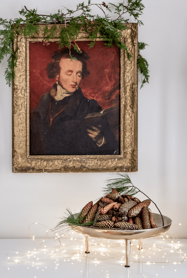 Twinkle lights and pine cones in bowl