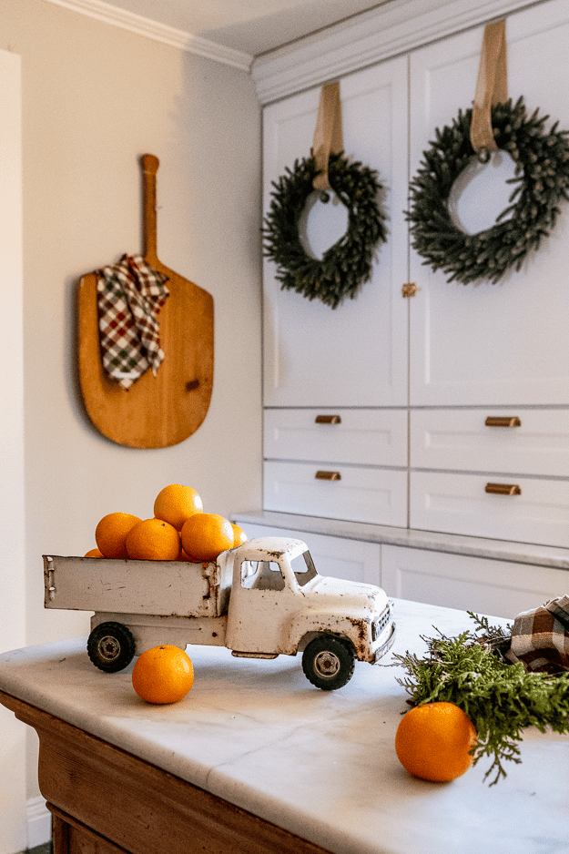 Vintage metal toy truck with clementines in bed for Christmas