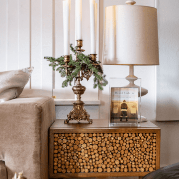 Wood end table with gold candelabra with greenery for christmas