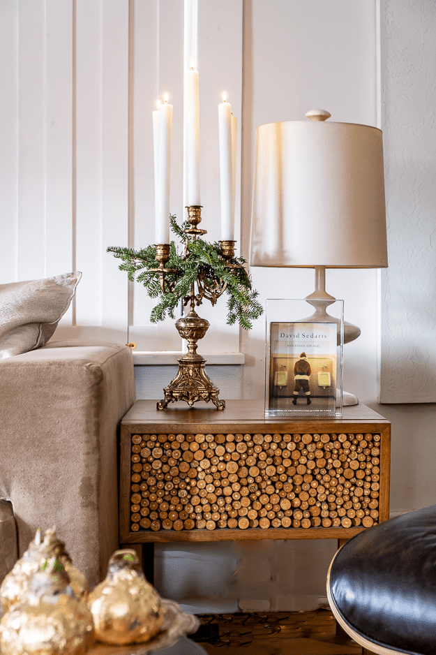 Wood end table with gold candelabra with greenery for christmas