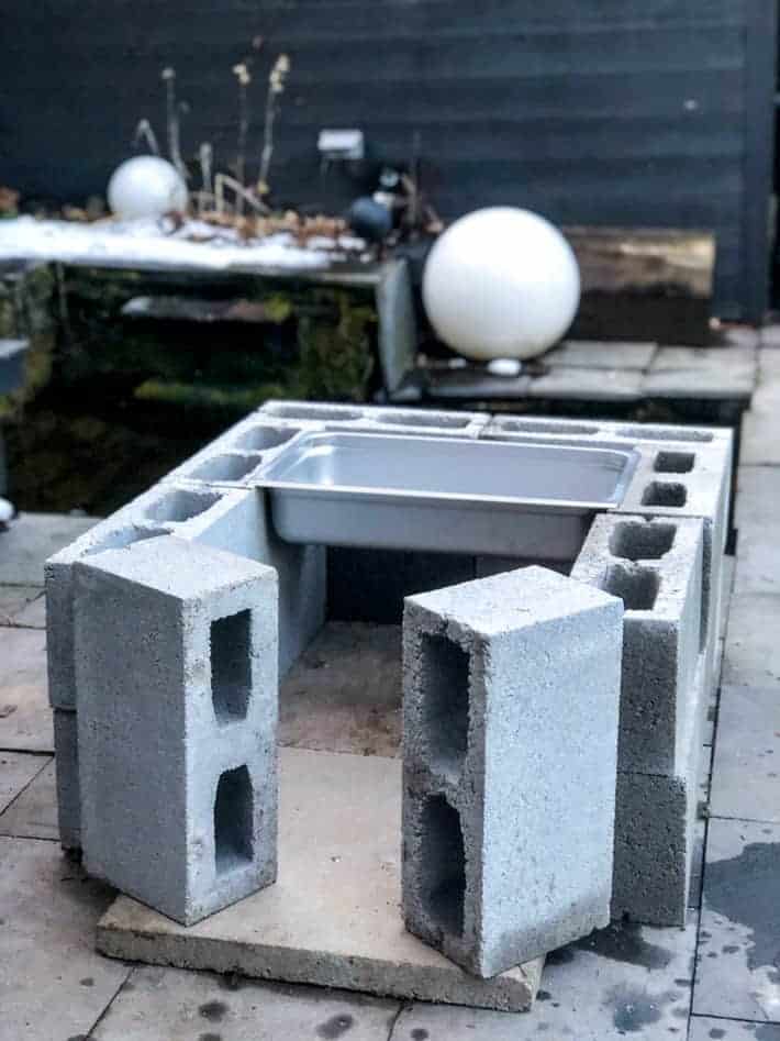 A cinderblock fire pit made for boiling maple syrup.