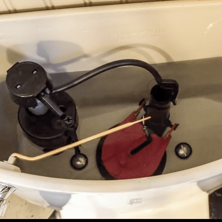 Adjusting toilet tank float.