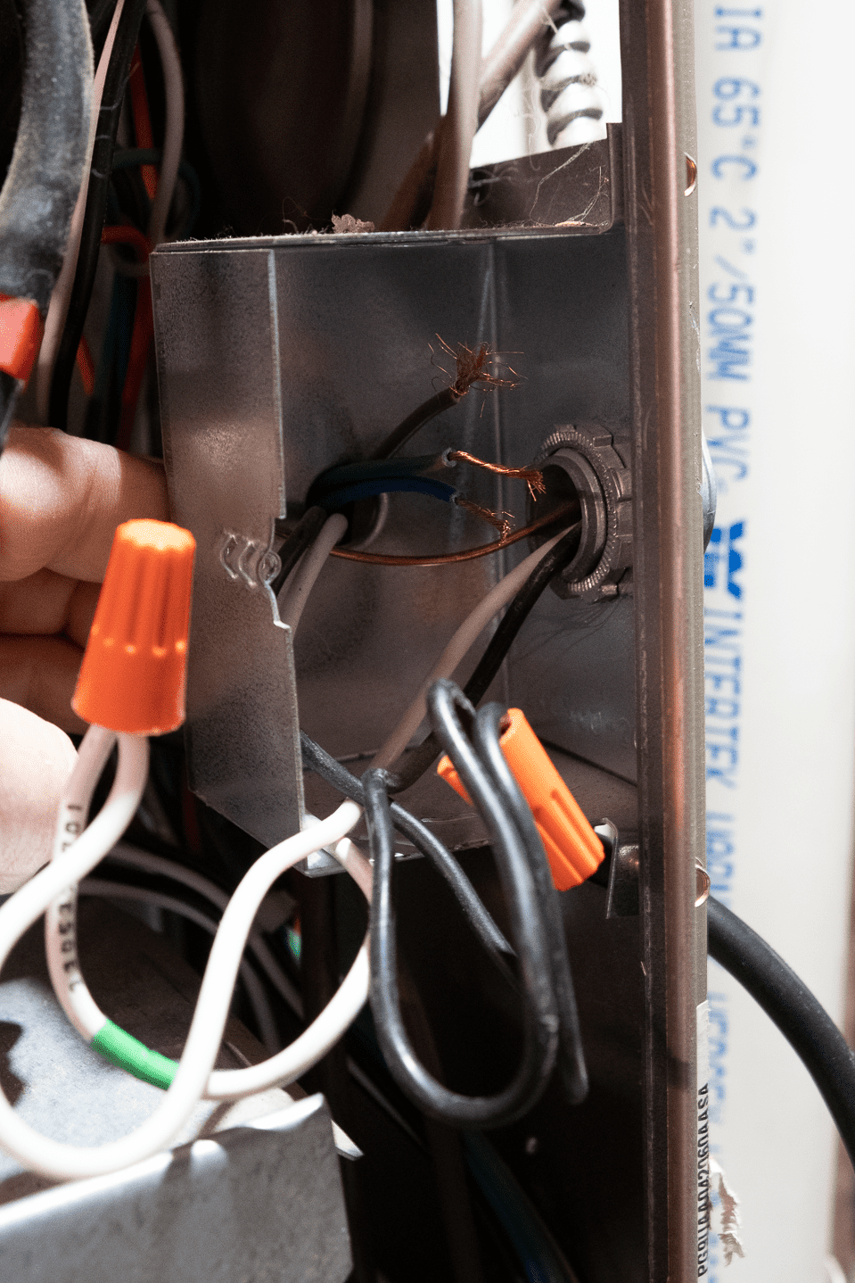 New wires fed into the back of furnace's electrical box.