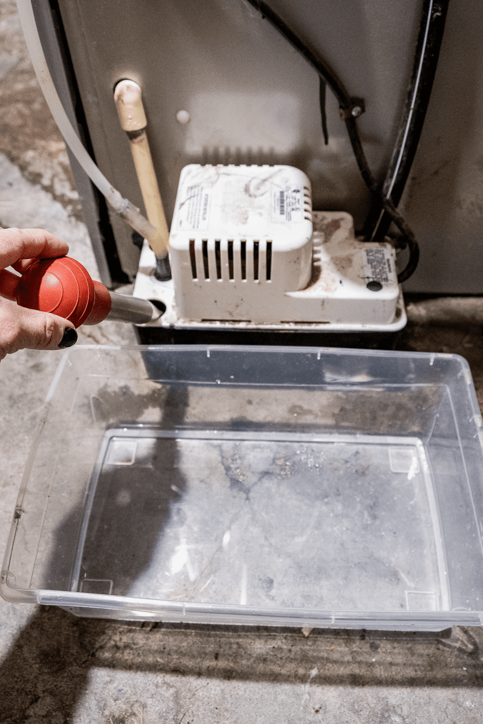 Suctioning water out of pump reservoir.