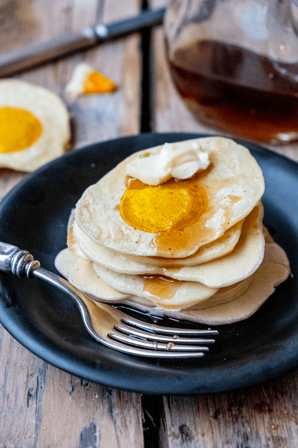 A stack of pancakes that look like fried eggs.