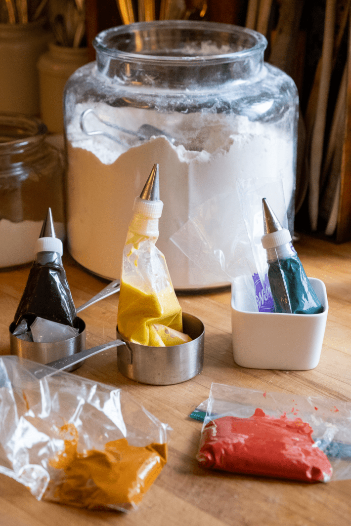 Colored pancake batter in piping bags.