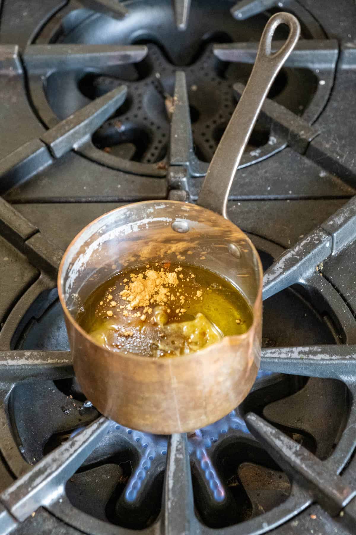 Copper pot with CBD gummy ingredients before mixing.