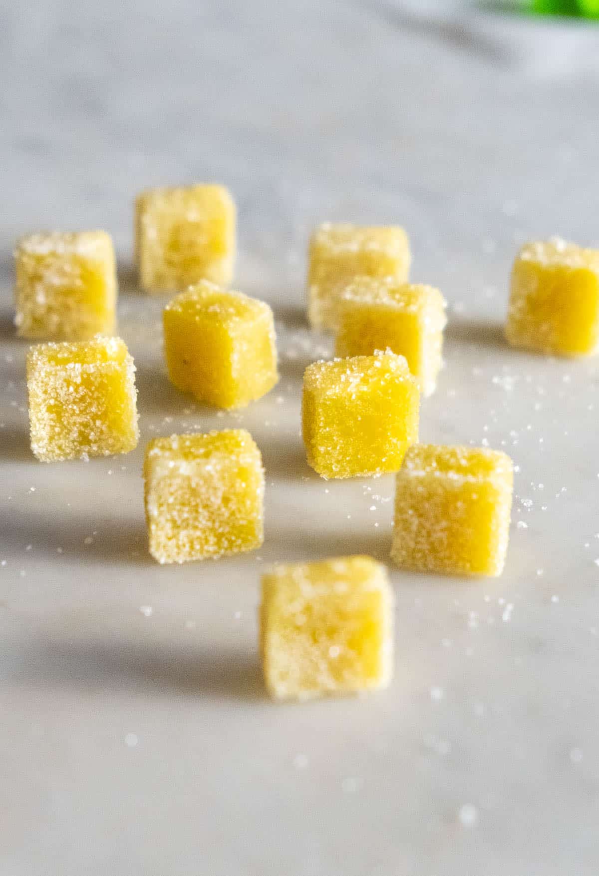 Bright yellow CBD gummies with a sour sugar coating.