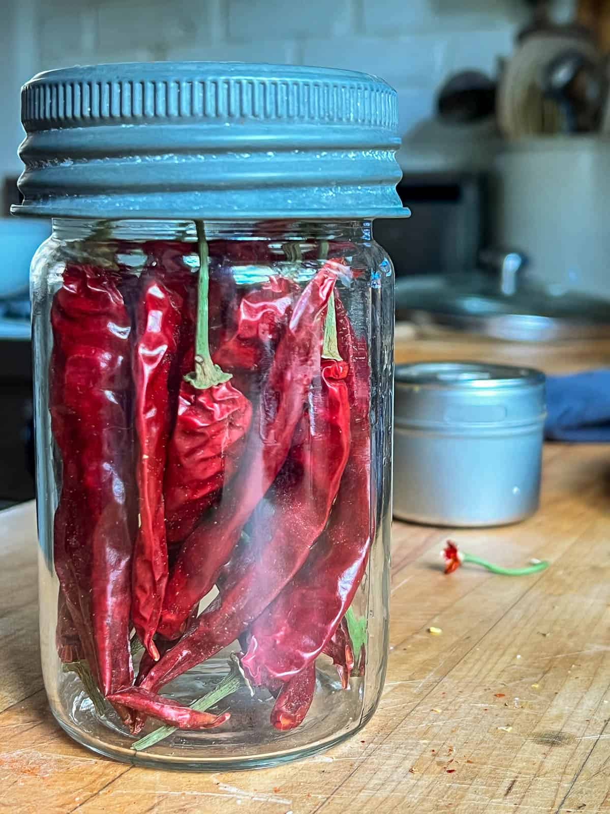 Dried chili peppers in an old fashioned mason jar.