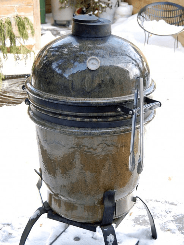 Glazed ceramic Cypress grill standing in the snow.