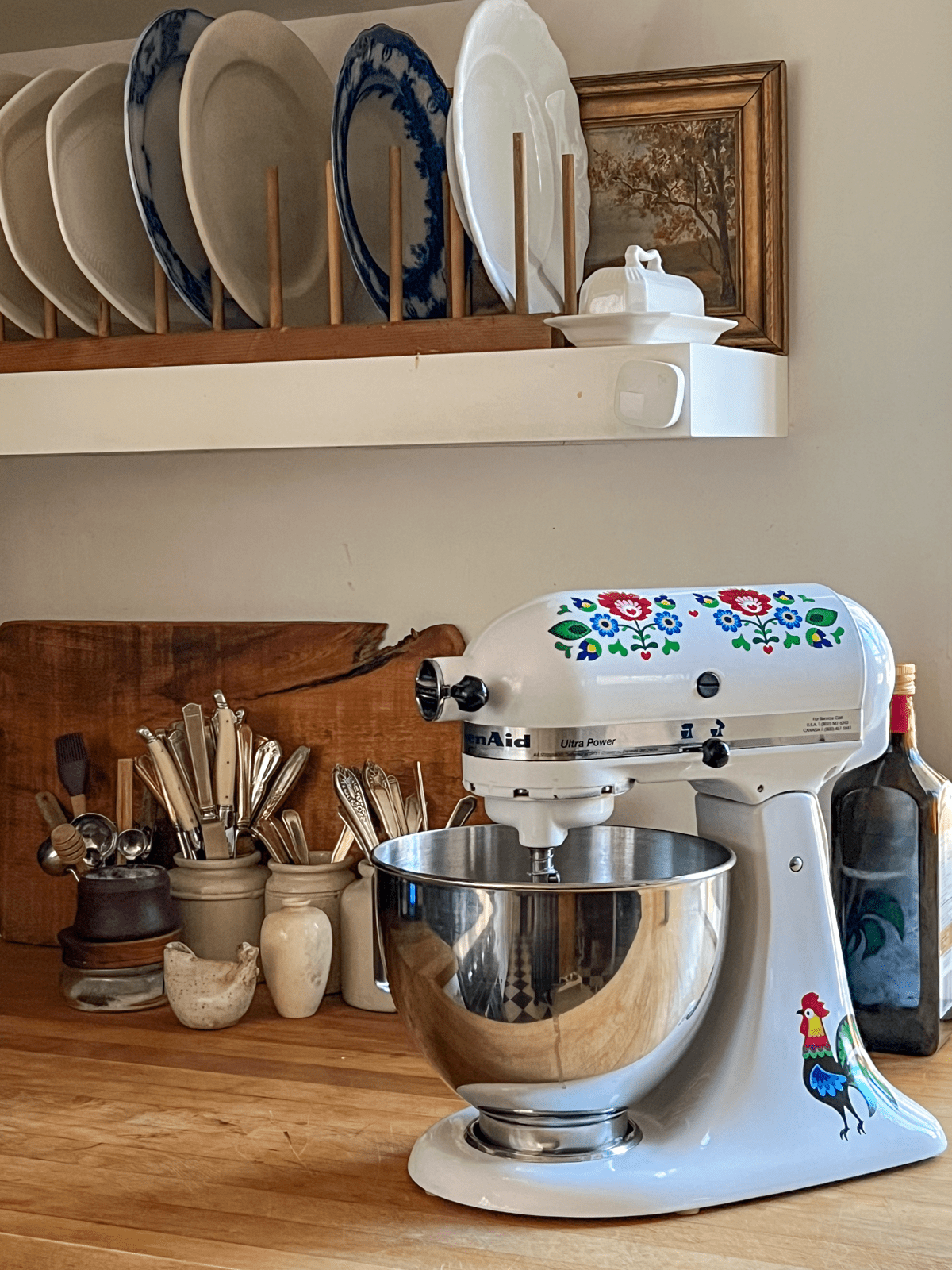 White Kitchen Aid in country kitchen with folk art decals.