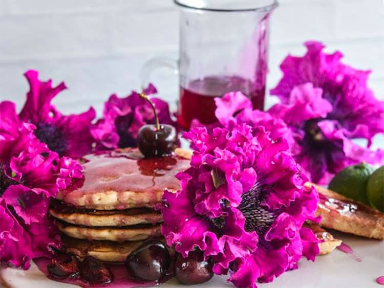 Cosmic Cherry Petunia with a stack of pancakes and cherries