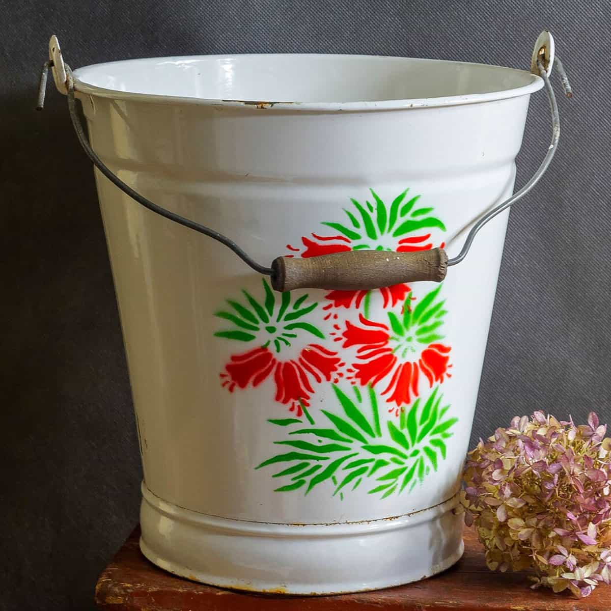 Vintage white enamel pail with red and green flowers painted