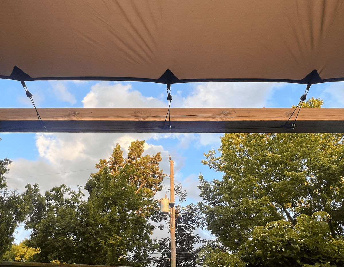 Tent attached to pergola top for DIY pergola cover.