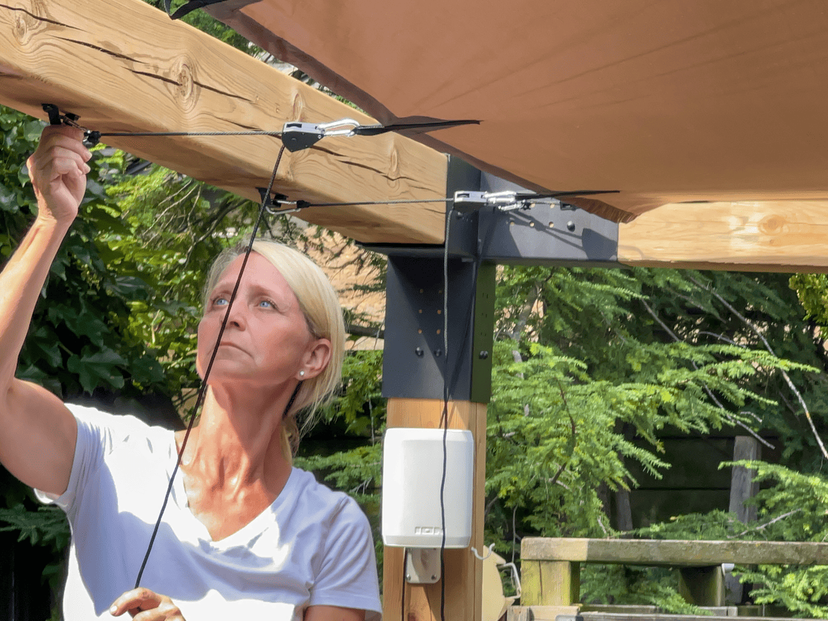 Connecting pulleys for tightening DIY pergola cover.